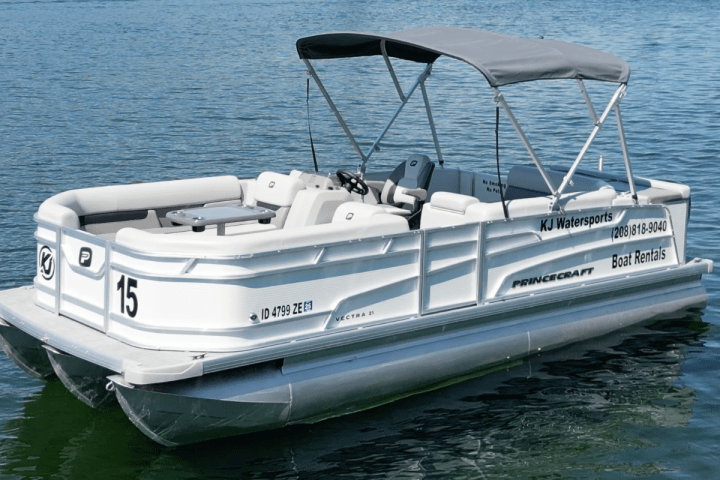 Pontoon boat on water with rental company details and number 15 visible on the side.
