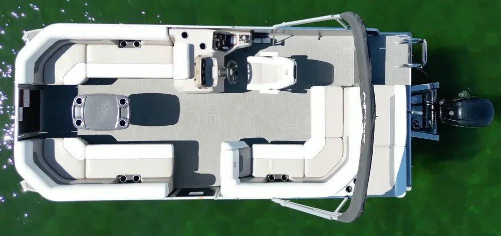 Aerial view of an empty pontoon boat on green water.