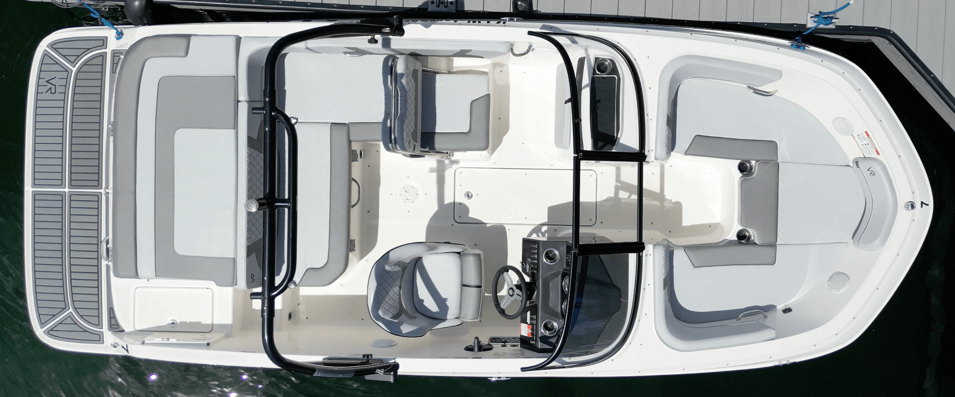 Overhead view of a white motorboat docked on water.