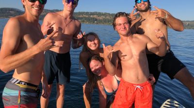 a group of people standing next to a body of water
