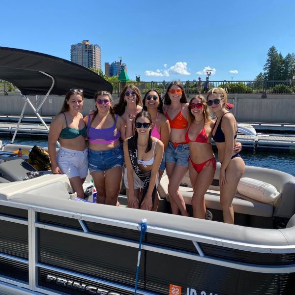 a group of people on a boat posing for the camera