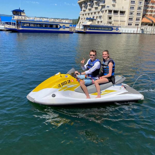a person riding on the back of a boat in a body of water