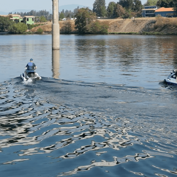 a group of people rowing a boat in a body of water