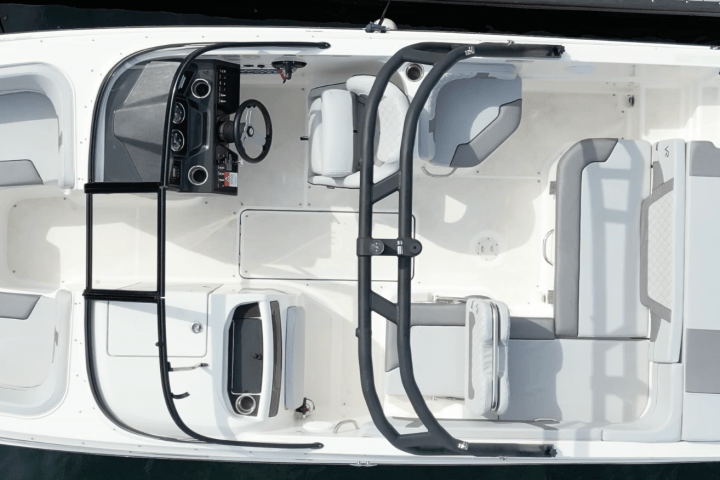 Bird's-eye view of a white motorboat docked at a pier.